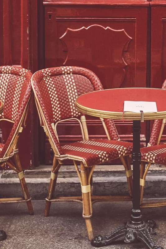 Red chairs near table in Paris cafe